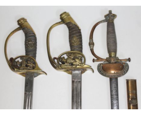 A group of three swords comprising two Imperial German infantry officer's swords, one marked 'PO&amp;Co' and the other 'WK&am