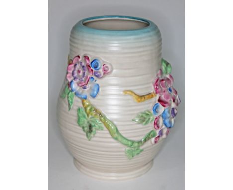 A Clarice Cliff vase with moulded floral decoration, printed Newport pottery mark to base, numbered 899, height 21cm.&nbsp;Co