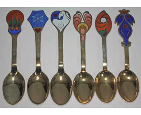A set of six Danish silver gilt and enamel year spoons each with a different enamelled design and date, marked 'A Michelsen S