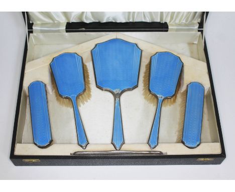 A cased Art Deco hallmarked silver and blue enamel dressing table set.&nbsp;Condition - damage to enamel on hand mirror and t