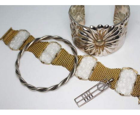 A mixed lot of jewellery comprising a yellow metal bracelet set with carved colourless paste panels, a flower bangle marked '