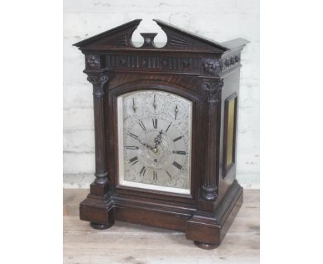 An Edwardian oak mantle clock with architectural cornice, Corinthian columns, steel dial with three subsidiary dials: 'Chime/