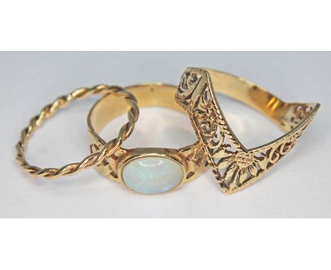 A group of three hallmarked 9ct gold rings comprising one set with an oval precious opal cabochon in a Celtic style band, a t