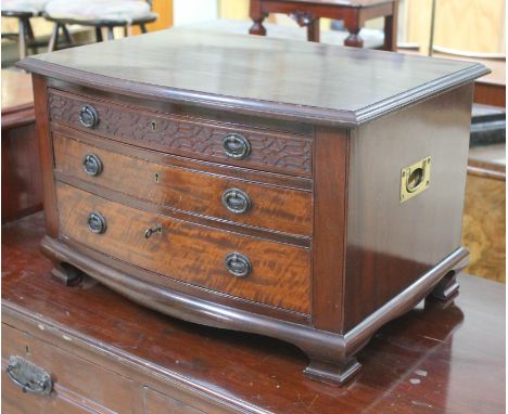 An Edwardian bow front mahogany canteen chest in the Chippendale style with carved 'frieze' drawer, neo-classical style handl