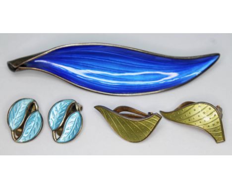 A group of Norwegian Modernist silver and enamel jewellery comprising a blue enamel brooch by Arne Nordlie length 81mm, a pai