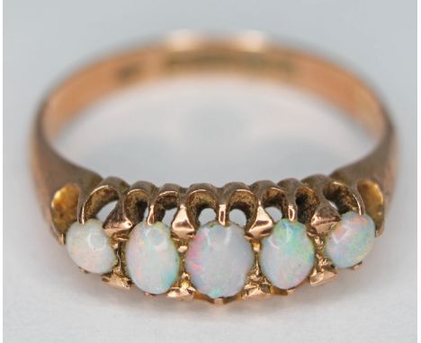 A hallmarked 9ct gold five stone precious opal ring, gross wt. 2.72g, size P.  