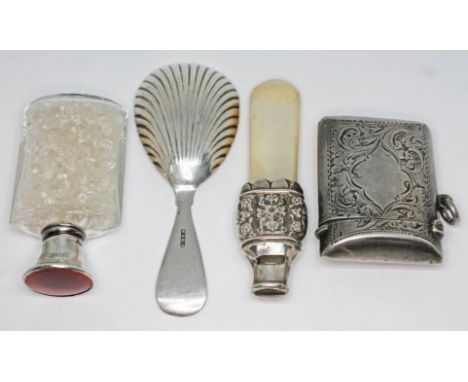 A mixed lot comprising a hallmarked silver vesta, a cut glass scent bottle with hallmarked silver and red enamel top, a white