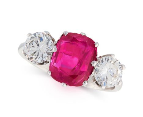 A BURMA NO HEAT RUBY AND DIAMOND THREE STONE RING set with a cushion cut ruby of 2.96 carats between two round cut diamonds t