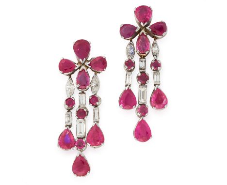 A PAIR OF RUBY AND DIAMOND EARRINGS in 18ct white gold, each designed as a cluster of four pear cut rubies suspending a trio 