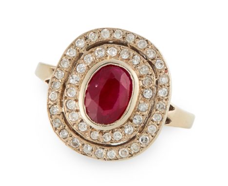 A RUBY AND DIAMOND CLUSTER RING set with an oval cut ruby of 0.49 carats in a double row cluster of round cut diamonds, unmar