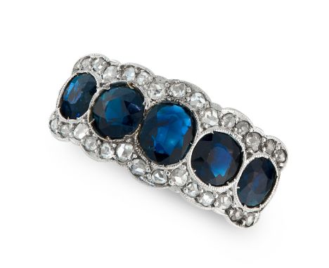 A SAPPHIRE AND DIAMOND RING in platinum, comprising of a row of five alternating round and oval cut sapphires, accented by tw