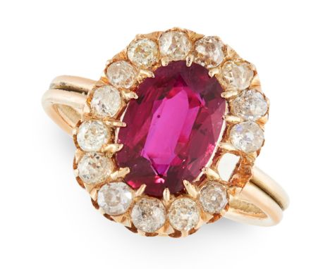 A RUBY AND DIAMOND CLUSTER RING in yellow gold, set with an oval cut ruby of 2.07 carats in a border of old cut diamonds, unm