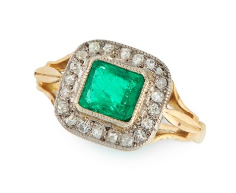 AN EMERALD AND DIAMOND CLUSTER RING in 18ct yellow gold, set with a step cut emerald of 0.80 carat in a border of old cut dia