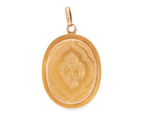 AN ANTIQUE MOURNING LOCKET PENDANT in yellow gold, the oval hinged body with engraved foliate decoration to the outside, with