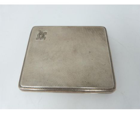 A silver cigarette case with engine turned decoration, London, 1948, gilded interior, Bravingtons Ltd. Monogram front. (147g)