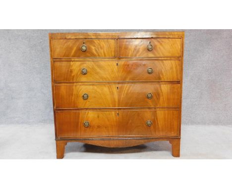 A Georgian flame mahogany chest of two short over three graduating long drawers on bracket feet. H.106 W.107 D.49cm 