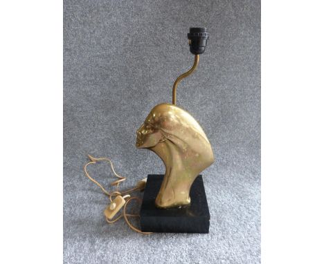 An Art Deco brass lamp with side profile of a lady, mounted on a painted wooden base. H 47cm. 