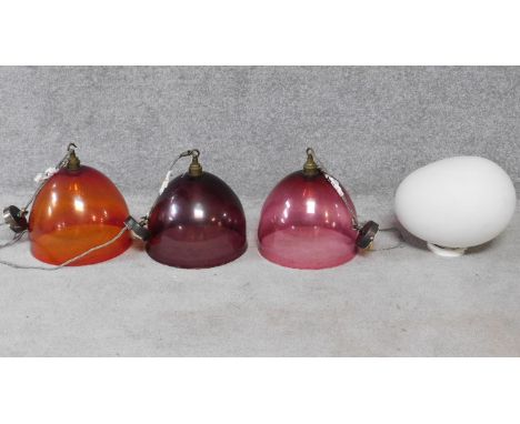 Three bespoke hand blown glass hanging lights retailed by Curiousa &amp; Curiousa and a frosted white glass pebble ceiling li