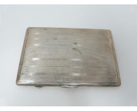 A rectangular engine turned decorated cigarette case, Birmingham, 1946, E J Houlston, engraved to gilded interior. (195g) 