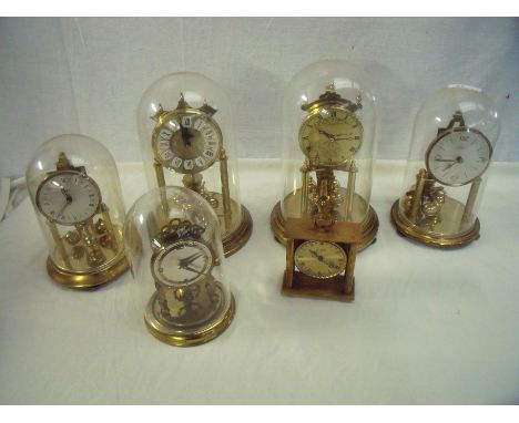 Selection of brass torsion clocks including Kundo and small brass carriage style clock
