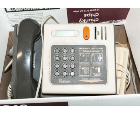 A vintage payphone and two telephones