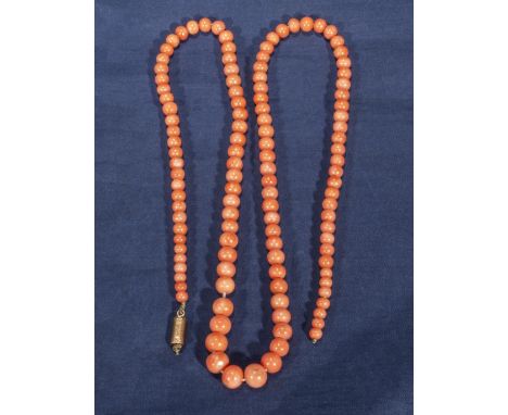 A vintage string of light coloured coral beads