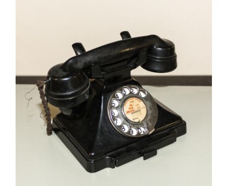 A vintage bakelite telephone.