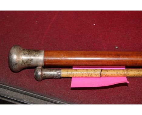 A silver mounted walking stick and another smaller (dented)
