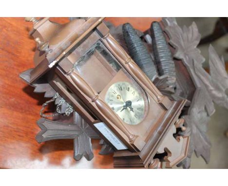 20TH CENTURY CARVED CUCKOO CLOCK
with a carved chalet pediment, with Roman numeral chapter ring, carved pendulum, with two we