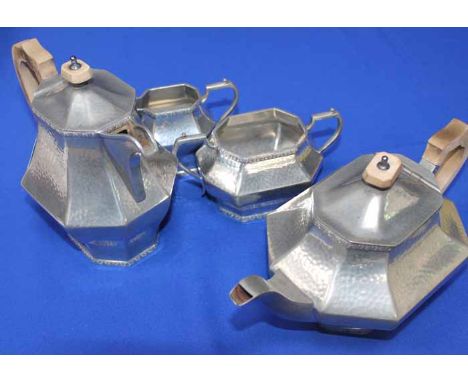 DON PEWTER FOUR PIECE TEA SERVICE
with planished bodies; together with a pair of brass candlesticks, candlesticks 25cm high