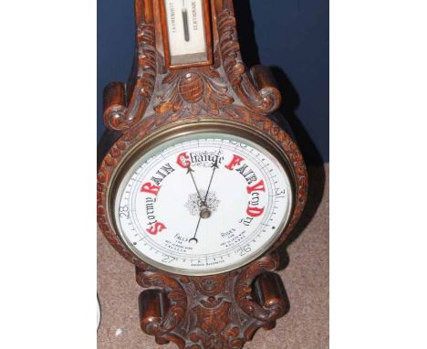 VICTORIAN CARVED OAK ANEROID WALL BAROMETER
with painted enamel indicator dial, 86cm high, good working order
