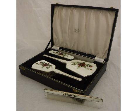 A silver four part vanity dressing table set, to include two brushes, a comb and a mirror with enamel rose decoration (by Low