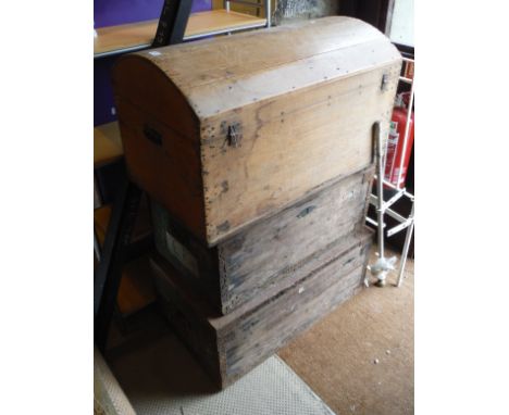 A pine dome topped trunk together with two wooden and iron bound trunks