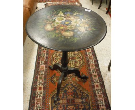 A Victorian painted slate tilt top circular occasional table, the top with hand painted floral spray on an ebonised baluster 