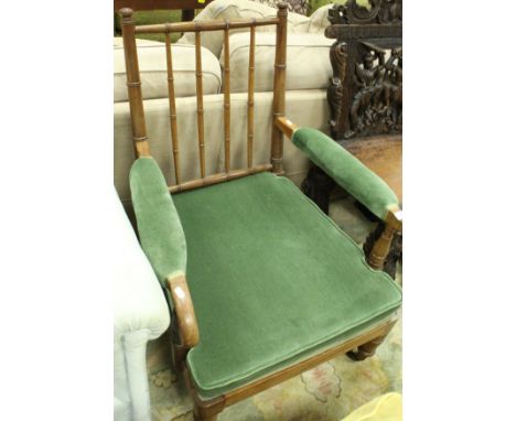 A 19th Century mahogany salon chair with ringed and turned stick back to upholstered arms and seat raised on ringed and turne