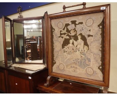 An Edwardian mahogany framed fire screen with needlepoint panel to centre, a mahogany triple framed dressing mirror, a mahoga