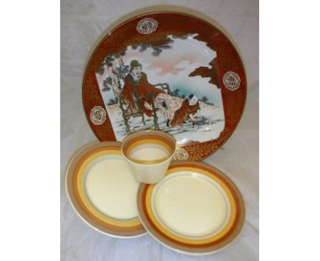 A Japanese Satsuma ware charger decorated with a scene of gentleman sat a chair, a child before him playing with his turtle, 