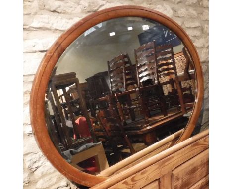 A mahogany framed oval wall mirror with bevelled glass CONDITION REPORTS Various scratches, scuffs and marks etc throughout. 