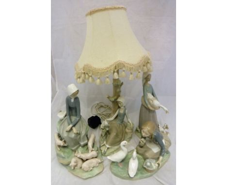 Four items of Lladro to include "Girl seated with piglets at her feet", "Girl carrying goose in basket with dog at her feet",