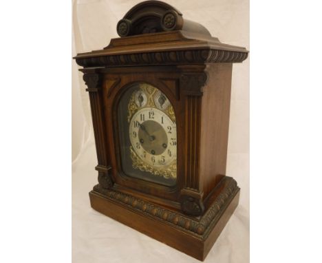 A late 19th Century German walnut cased mantle clock of architectural form, the 8-day musical movement by Junghans with brass