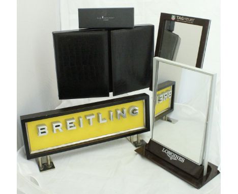 A Gucci brown leather pen collector's case, a Breitling advertising sign, a TAG Heuer mirror, a Longines mirror and an Elie B