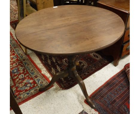 A late George III Provincial plumwood tea table, the circular snap top on a turned pedestal to tripod base