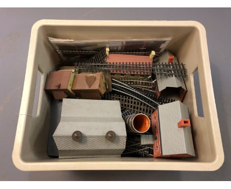 A box of 00 gauge track and model railway buildings.