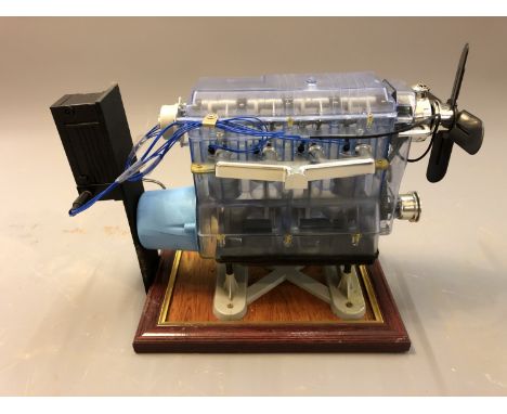 A plastic model of a combustion engine, on plinth, height 22cm.