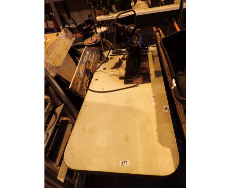 Vintage Singer industrial electric sewing machine on metal base with work light and cotton feeds 