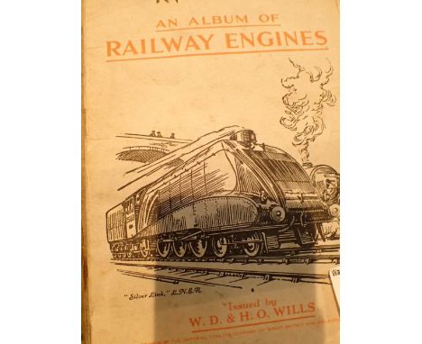 Three vintage car manuals Austin Triumph and a cigarette card album of railway engines 