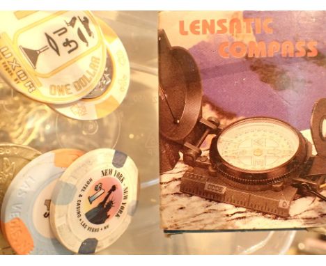 Lensmatic compass and five Las Vegas gaming tokens 