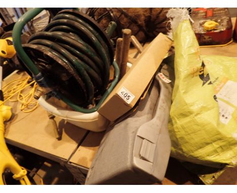 Collection of mixed tools and a roll of hose 