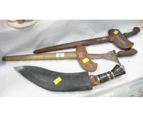 Two Malaysian Kris Panjang knives and a Kukri knife   This bladed lot is not for sale to people under the age of 18. By biddi