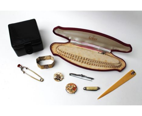 Lotus pearls, box of Her Majesty's Yacht Britannia commemorative napkin ring, thistle topped kilt pin, RAF tie pin, mother of